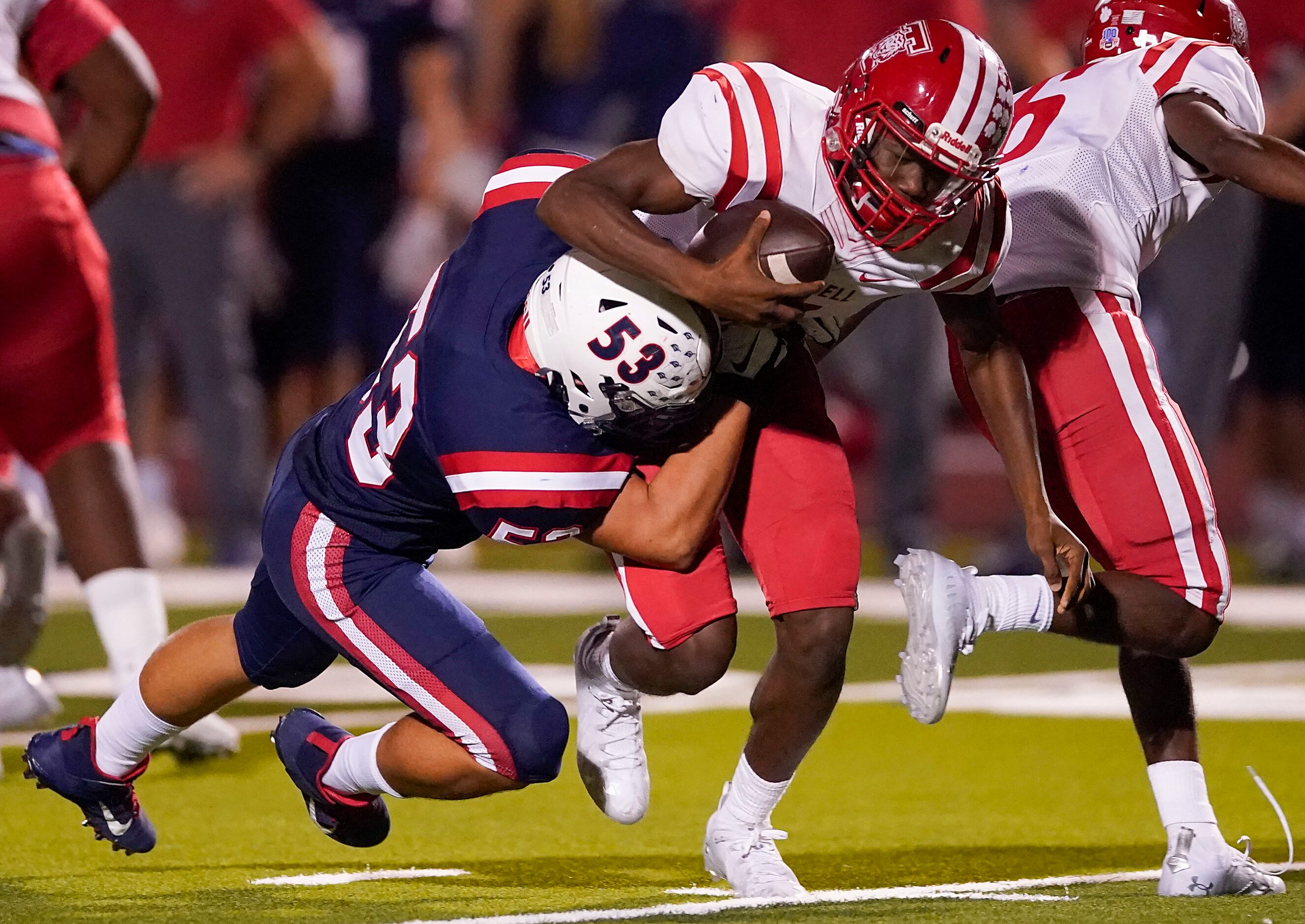 Terrell quarterback Kanye Nix (1) is dropped for a loss by Aubrey defensive lineman Gavin...