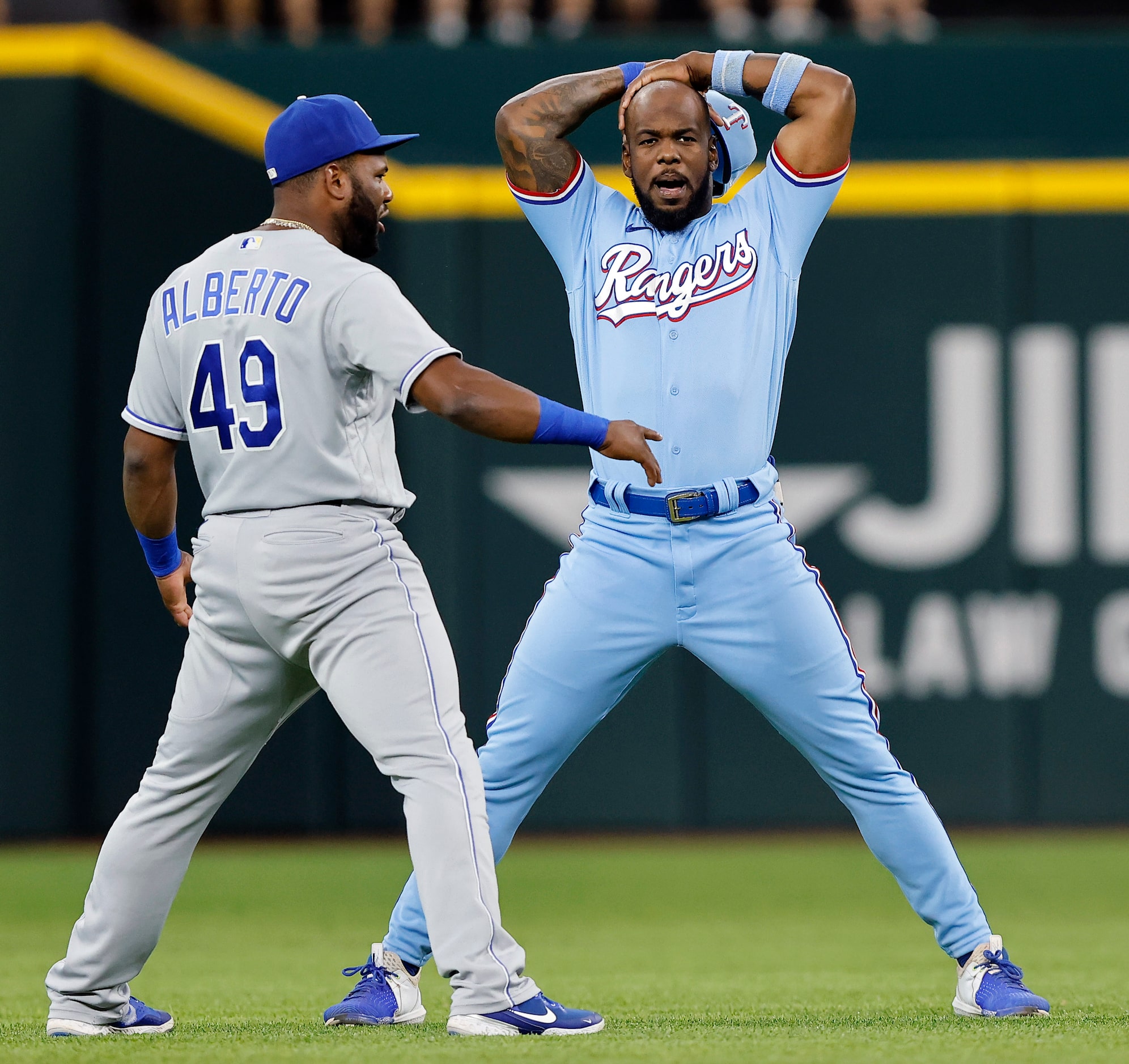 Texas Rangers Adolis Garcia (right) and Kansas City Royals Hanser Alberto (49) warm up for...