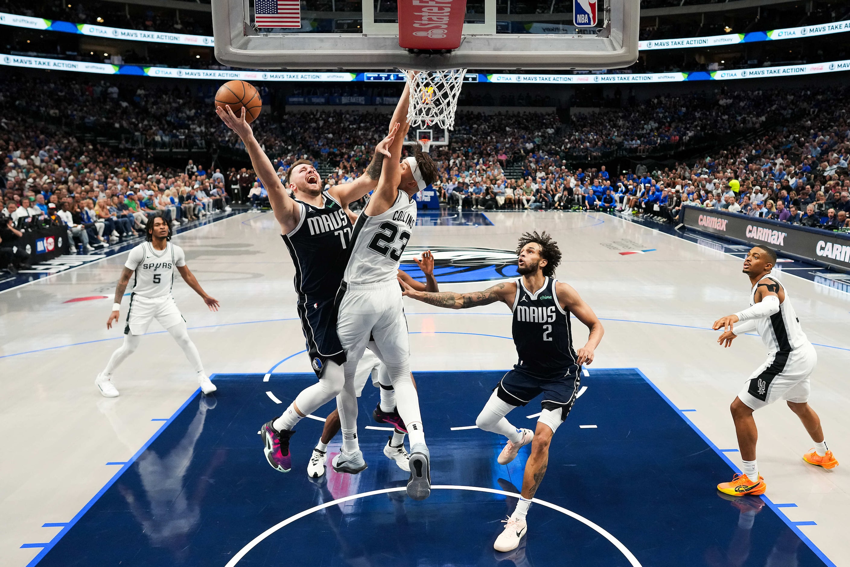 Dallas Mavericks guard Luka Doncic (77) drives against San Antonio Spurs forward Zach...