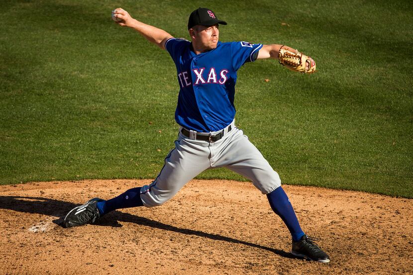Texas Rangers pitcher Adrian Sampson pitches during the seventh inning against the Chicago...
