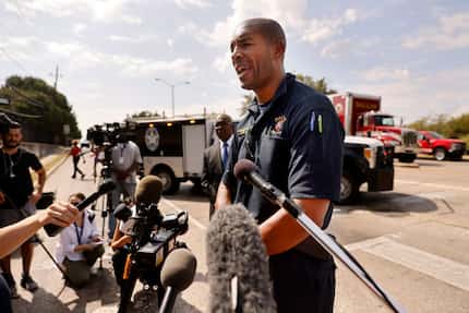 Dallas Fire-Rescue spokesman Jason Evans speaks to the media following an apartment...