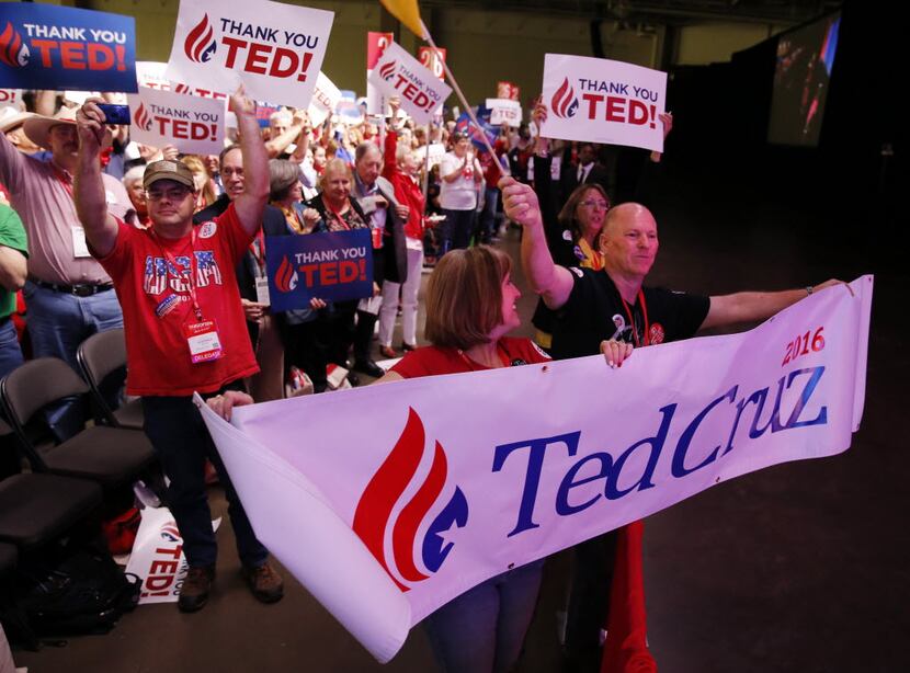 Collin County delegates Melissa and Richard Spence show their support for Sen. Ted Cruz as...