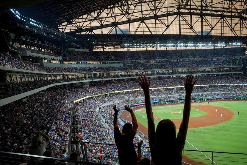 Fans cheer during a Texas Rangers game against the Chicago White Sox at Globe Life Field on...