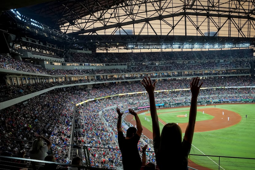 Fans cheer during a Texas Rangers game against the Chicago White Sox at Globe Life Field on...