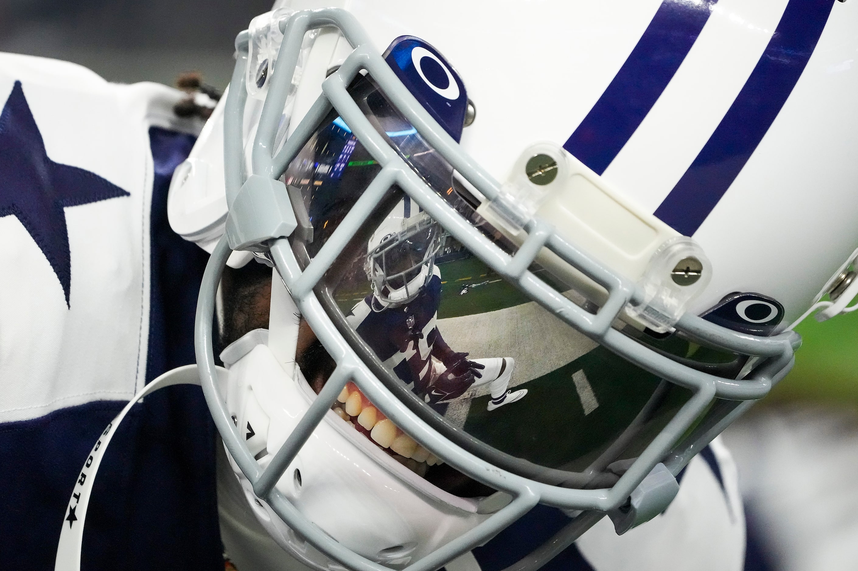 Dallas Cowboys safety Jayron Kearse (27) is reflected in the facemask  ofcornerback Trevon...