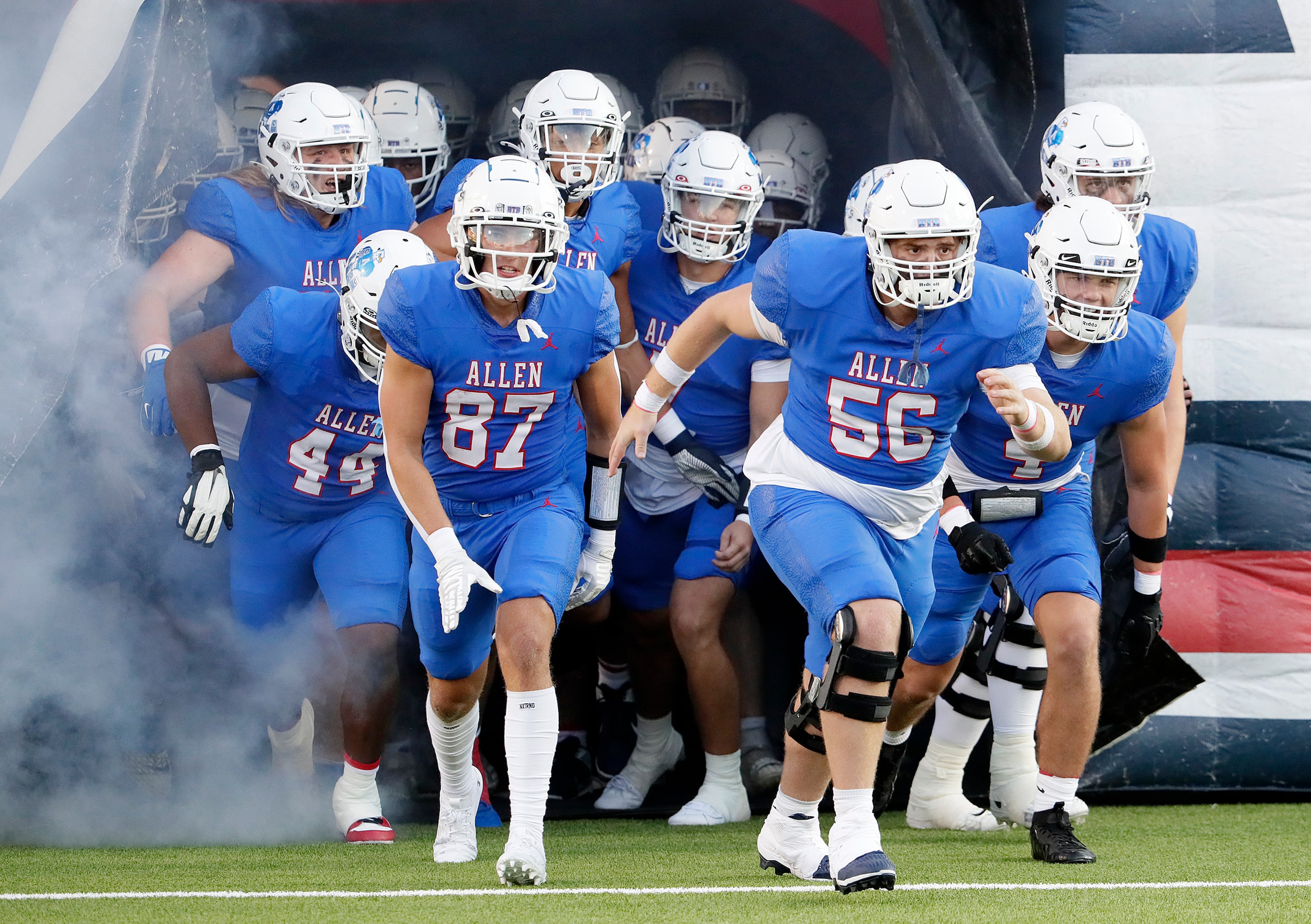 Allen High School offensive lineman Ethan Villarreal (56) leads the team onto the field...