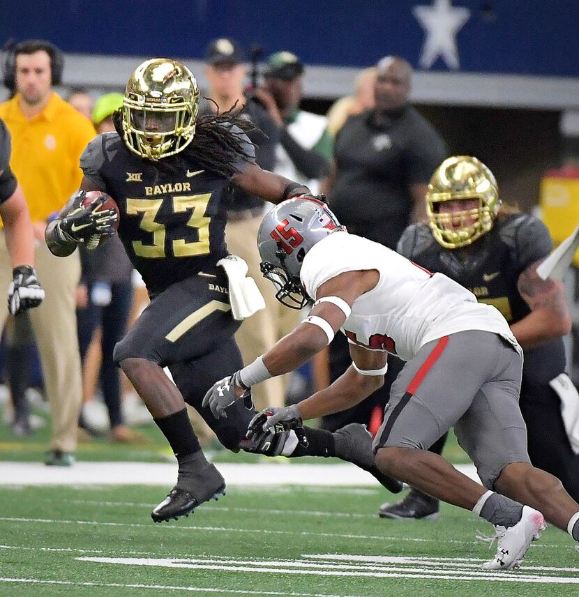 Baylor Bears running back JaMycal Hasty (33) is stopped by Texas Tech Red Raiders defensive...