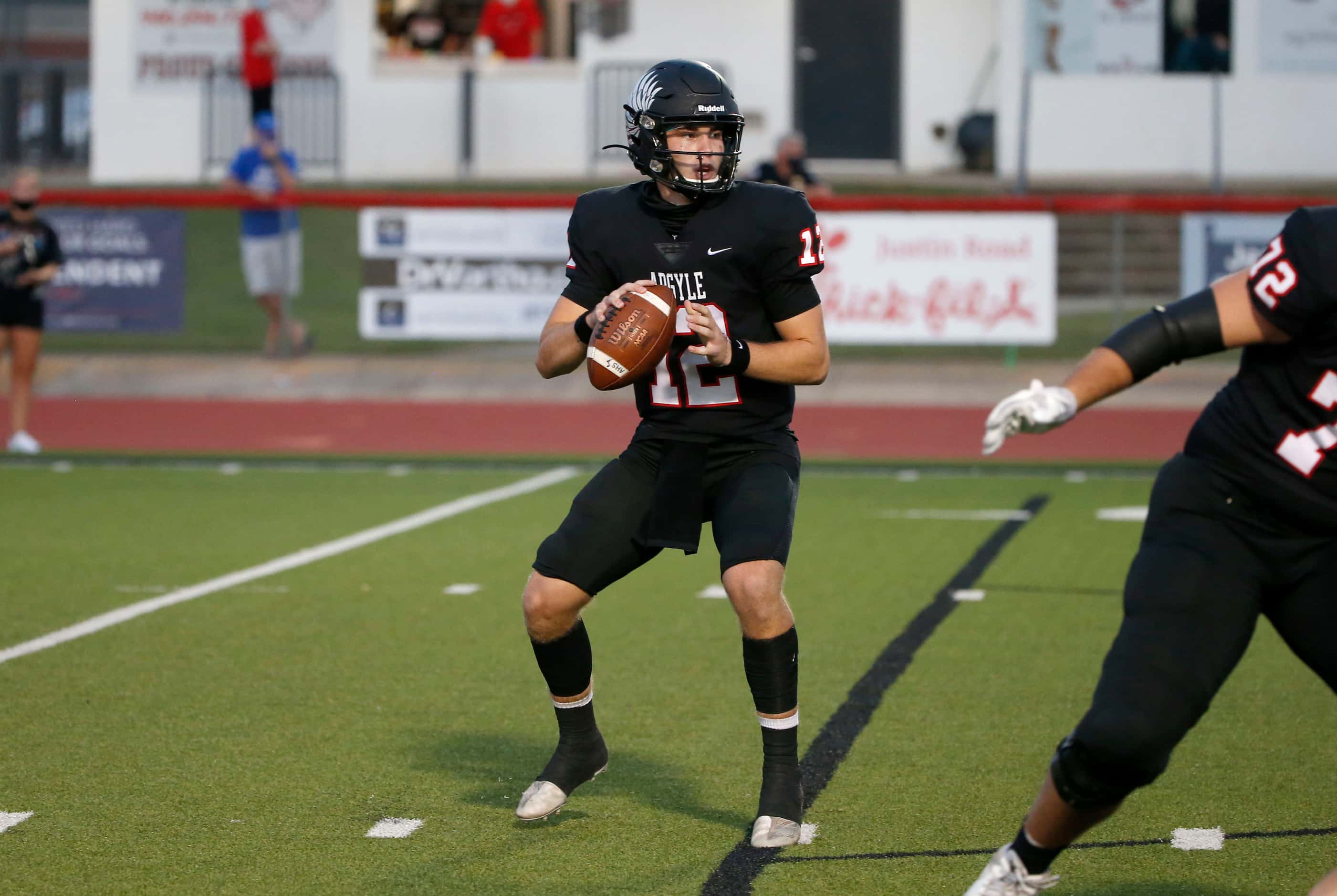 Argyle quarterback CJ Rogers (12) prepares to throw during a high school football game...