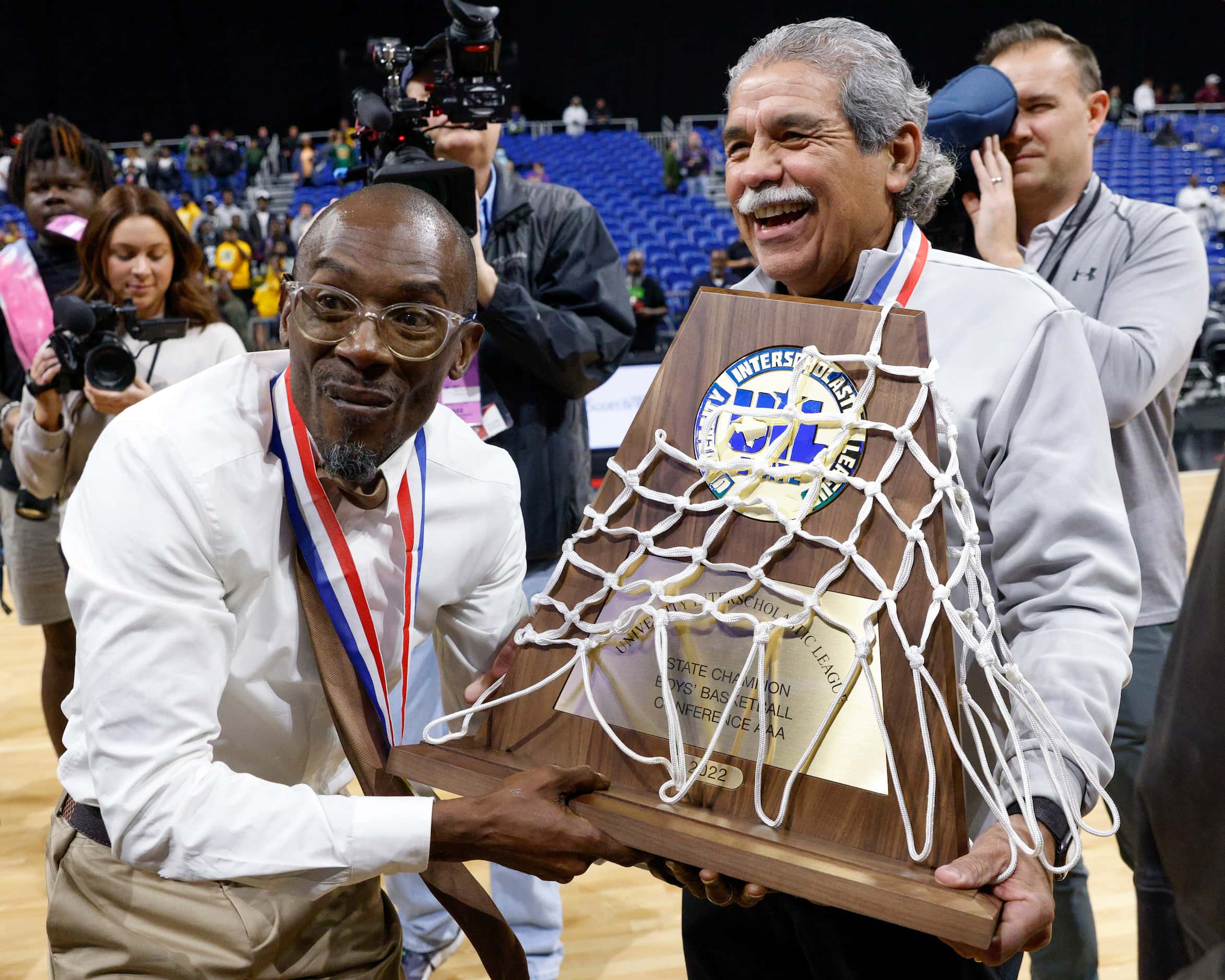 Madison head coach Damien Mobley accepts the Class 3A state championship trophy from Dallas...