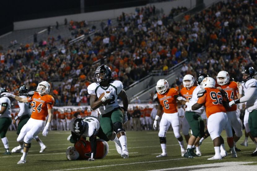 Mansfield Lake Ridge running back Carter Duke high steps it into the end zone after finding...