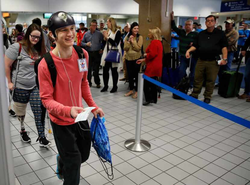 Jordan Palmer, 17, prepares to board the plane headed to Denver for a ski trip at DFW...