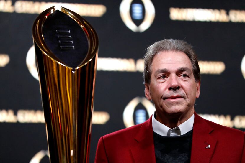 Alabama head coach Nick Saban poses next to the NCAA college football championship trophy at...