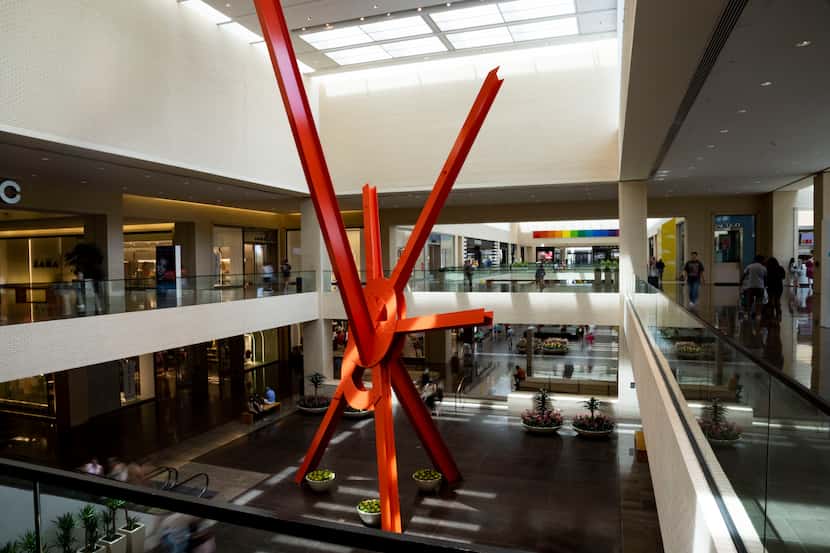 Shoppers walk by "Ad Astra," a sculpture by artist Mark di Suvero at NorthPark Center in...