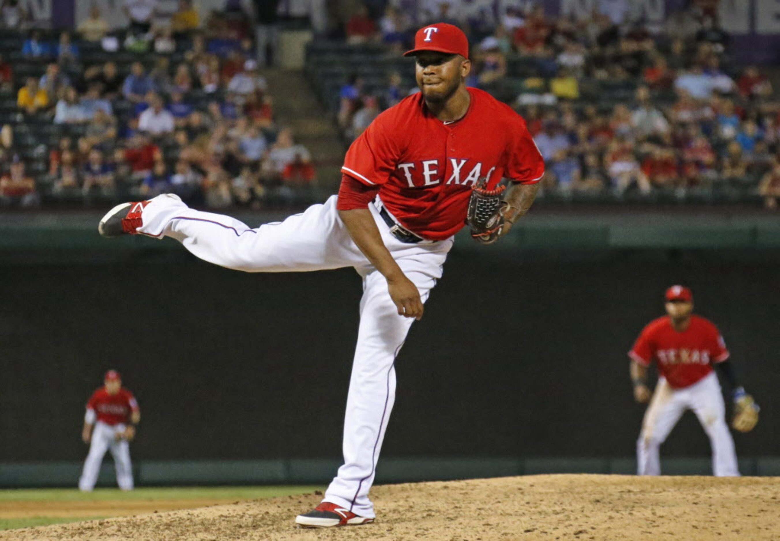 Texas relief pitcher Neftali Feliz throws a ninth-inning pitch during the Oakland Athletics...