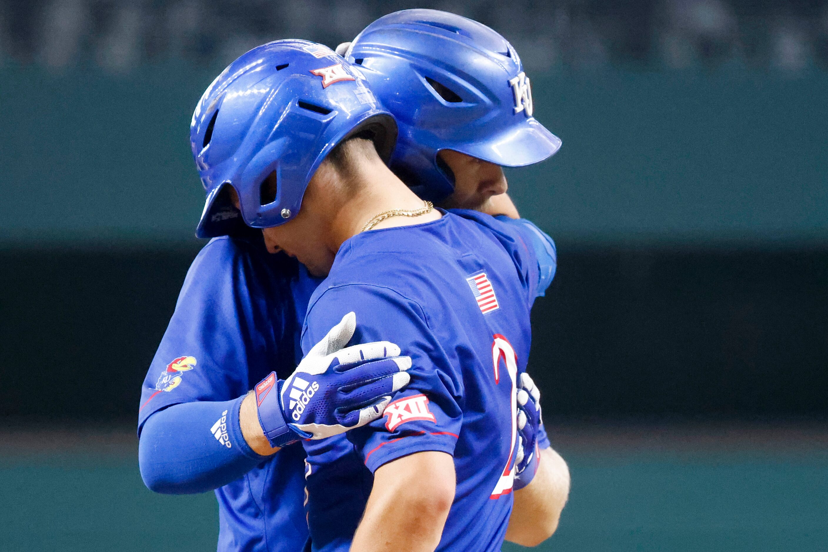 Kansas catcher Jake English (left) embrace outfielder Mike Koszewski after a homer by...