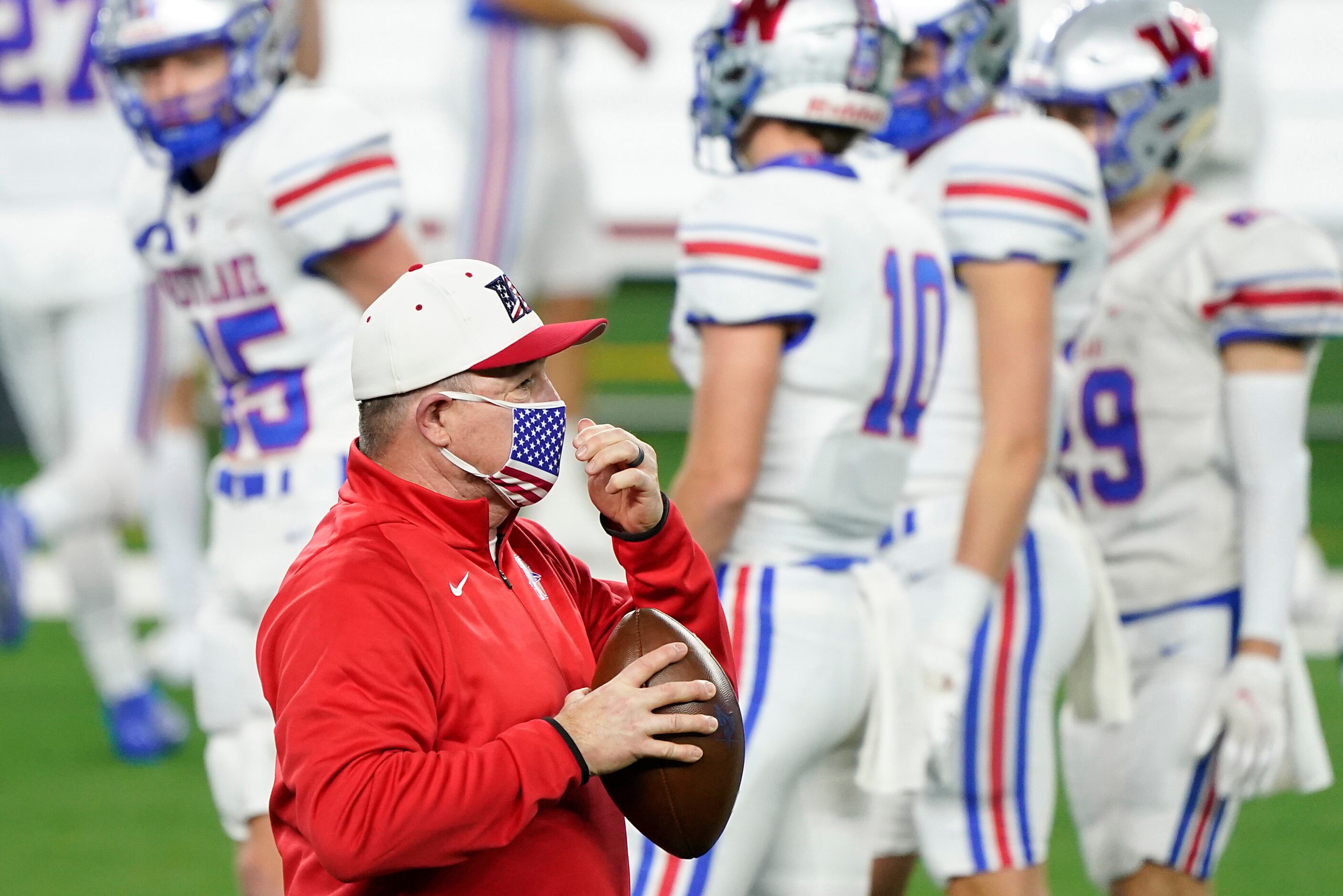 Austin Westlake head coach Todd Dodge watches his team warm up before the Class 6A Division...