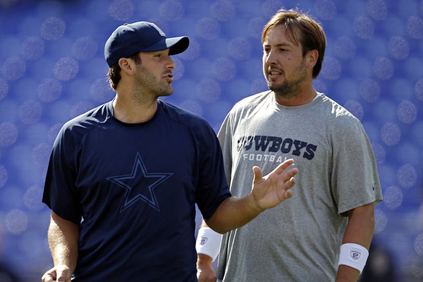 Dallas Cowboys quarterback Tony Romo (left) and quarterback Kyle Orton confer during warm...