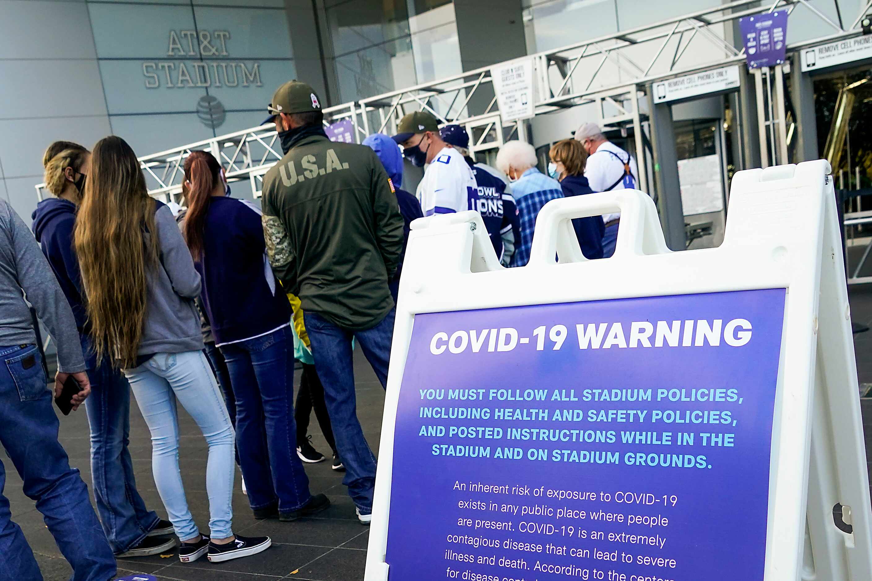 Fans wait for the gates to open before an NFL football game between the Dallas Cowboys and...