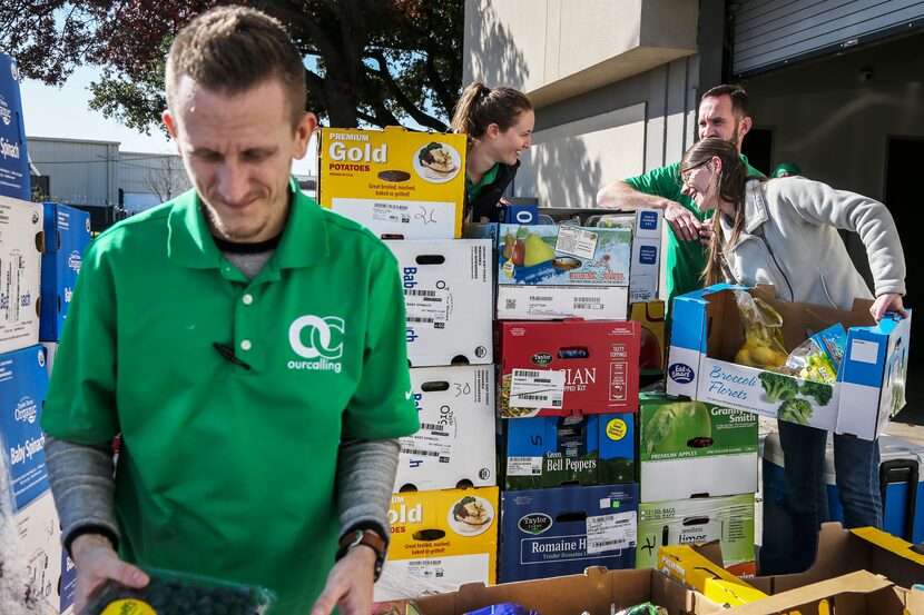 Joshua Brown, (left) operations technician, sorts through donated produce with other staff...