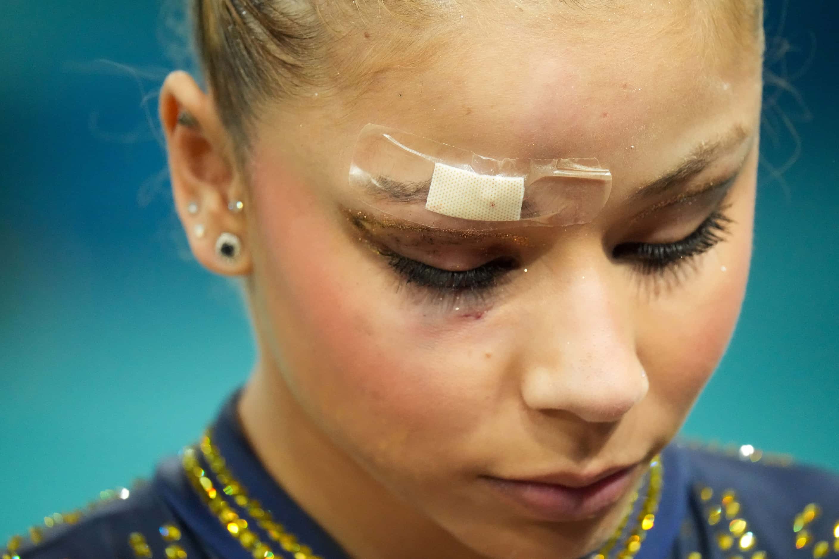 Flavia Saraiva of Brazil wears a bandage above her right eye after a fall while warming up...