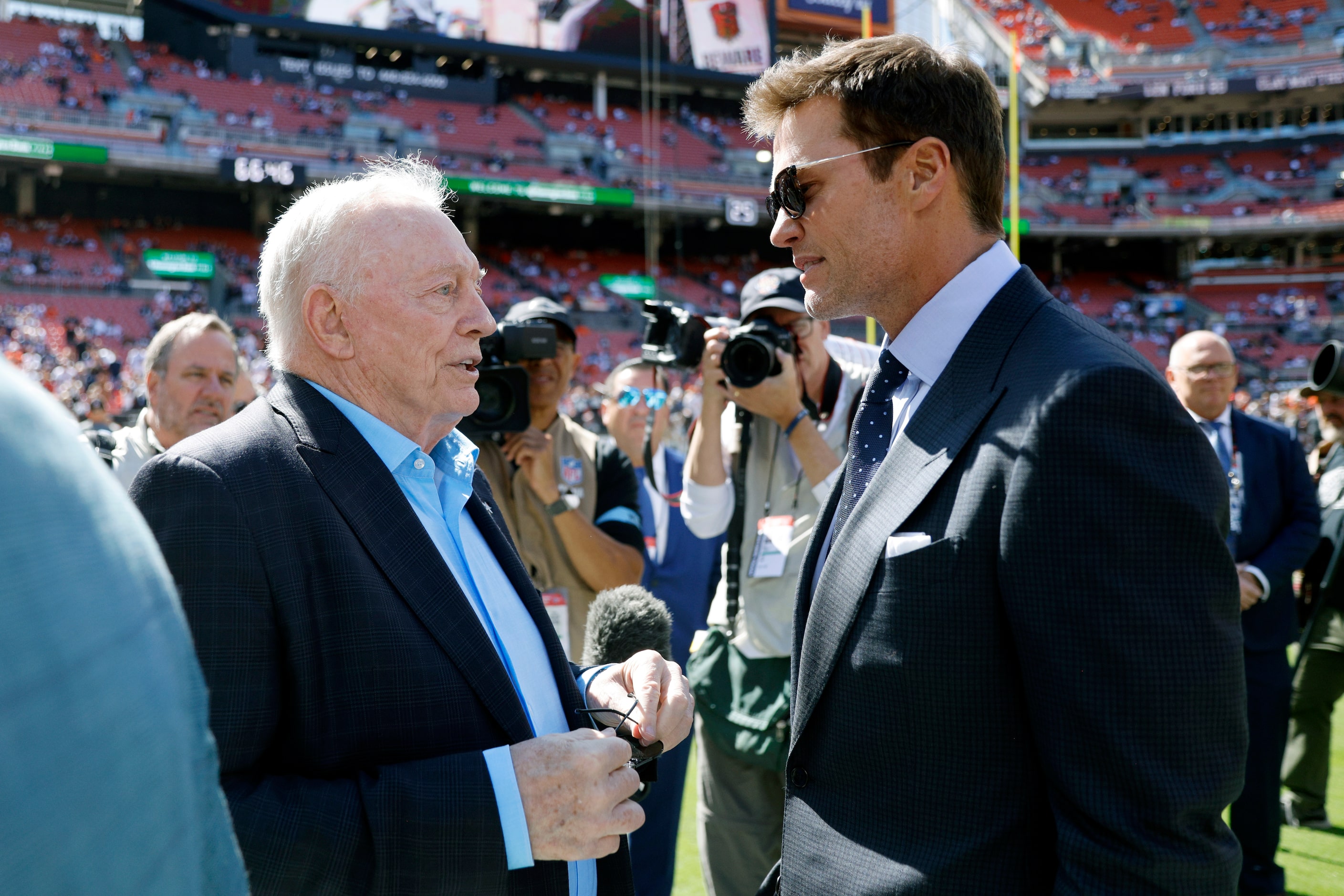 Dallas Cowboys owner Jerry Jones talks with former NFL player and Fox analyst Tom Brady...