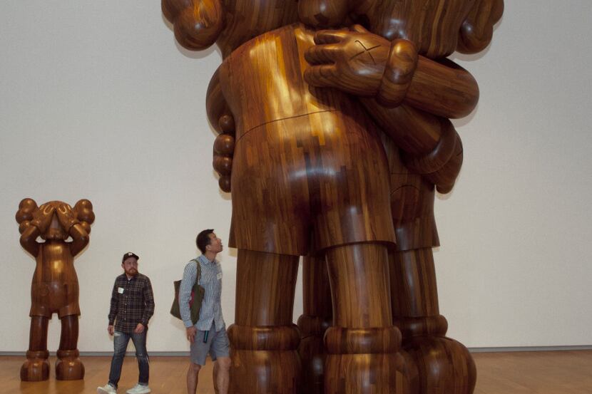 From left, AT THIS TIME, 2013 Wood and TOGETHER, 2016 Wood at the exhibition titled KAWS:...