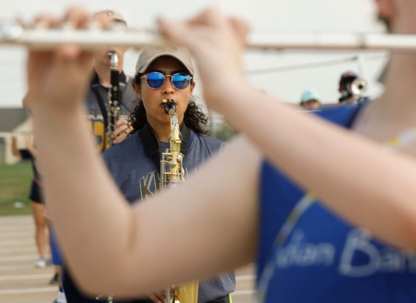 Keller High School Indian Band saxophone player Amanda Bernardi, 16, is framed by a fellow...