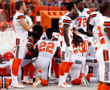 Members of the Cleveland Browns kneel during the national anthem before an NFL preseason...