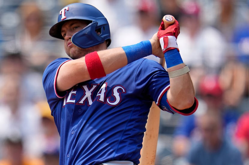 Texas Rangers' Josh Jung follows through with a two-run double off Pittsburgh Pirates...