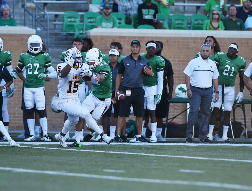 Frank Brown, Bobcat senior wide receiver, (15), breaks a tackle against Eric Keena, Mean...