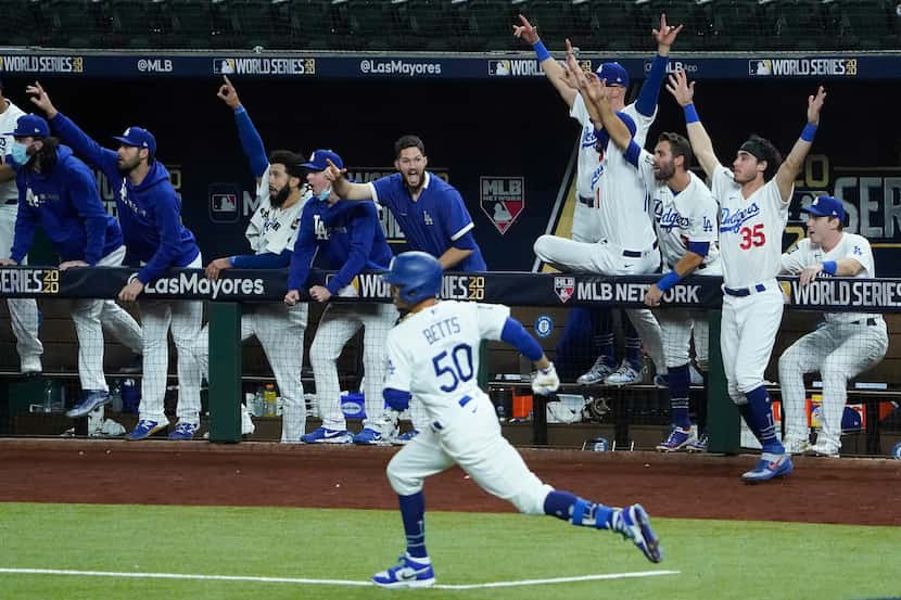 The Los Angeles Dodgers dugout erupts after right fielder Mookie Betts (50) hit a solo home...