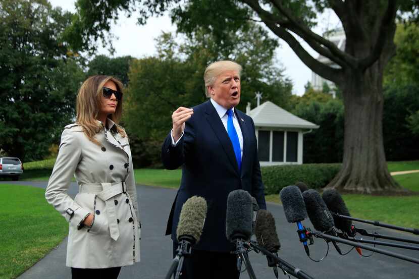 President Donald Trump with first lady Melania Trump speaks to reporters on the South Lawn...