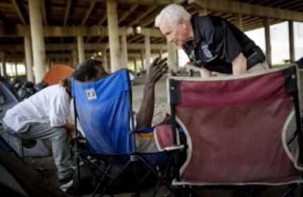  Dave Hogan, manager of the Dallas Police Department Crisis Intervention Unit, talks with a...