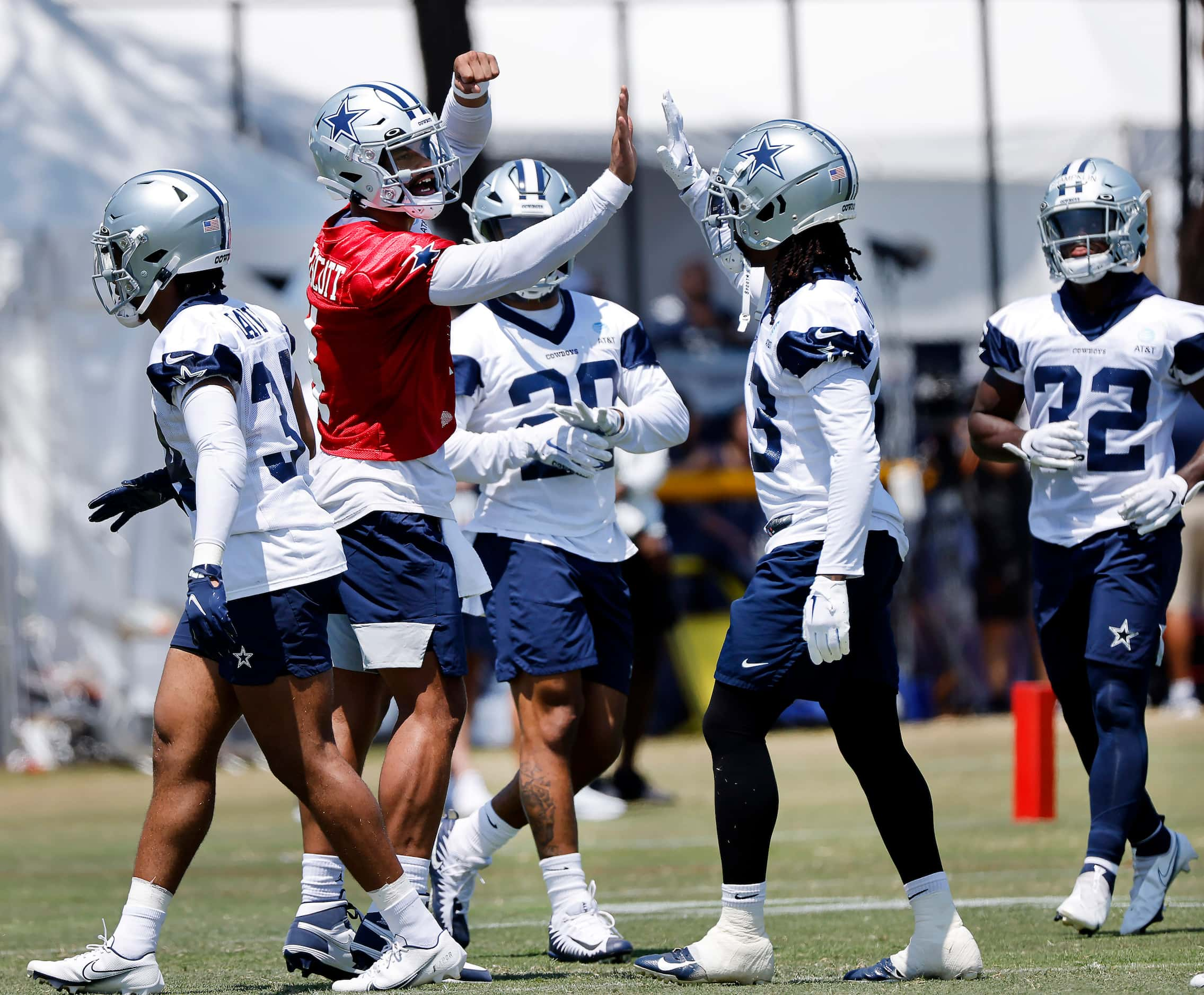 Dallas Cowboys quarterback Dak Prescott (4, seodnd from left) gets his offensive unit fired...