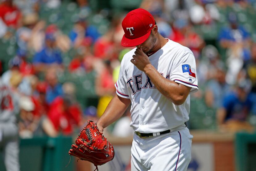 Texas Rangers starting pitcher Yu Darvish (11) reacts after giving ups run to Los Angeles...