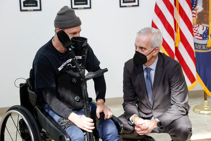 Army veteran John Caruso (left) spoke with Veterans Affairs Secretary Denis McDonough before...