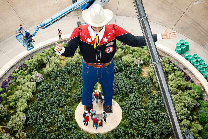 Workers install Big Tex in Fair Park on Friday, Sept. 22, 2017, in Dallas. The State Fair of...