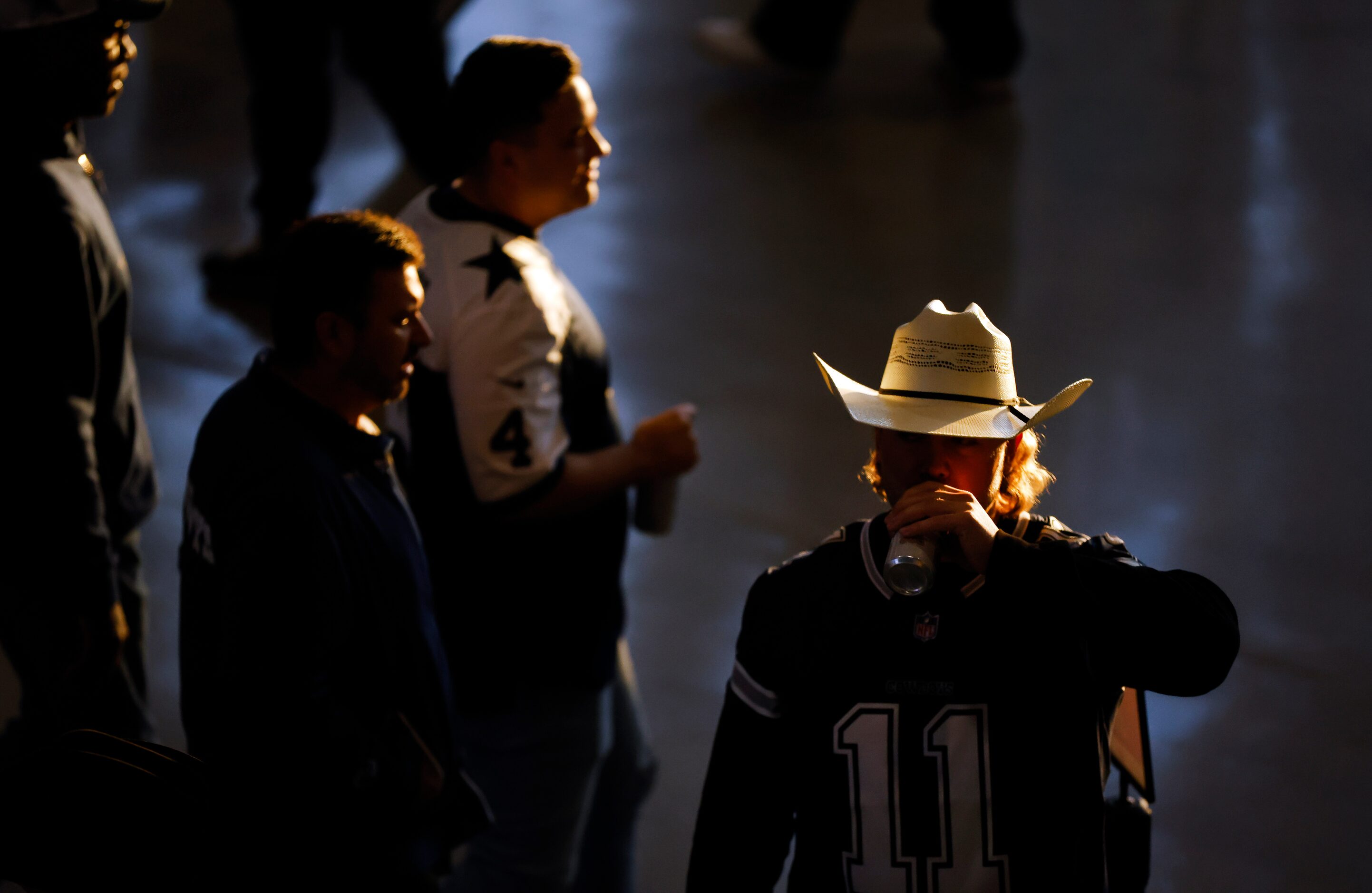 Dallas Cowboys fans drink beer on the end zone con course before the game against the...