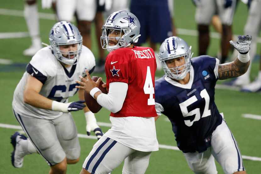Dallas Cowboys quarterback Dak Prescott (4) looks to pass as Dallas Cowboys defensive end...
