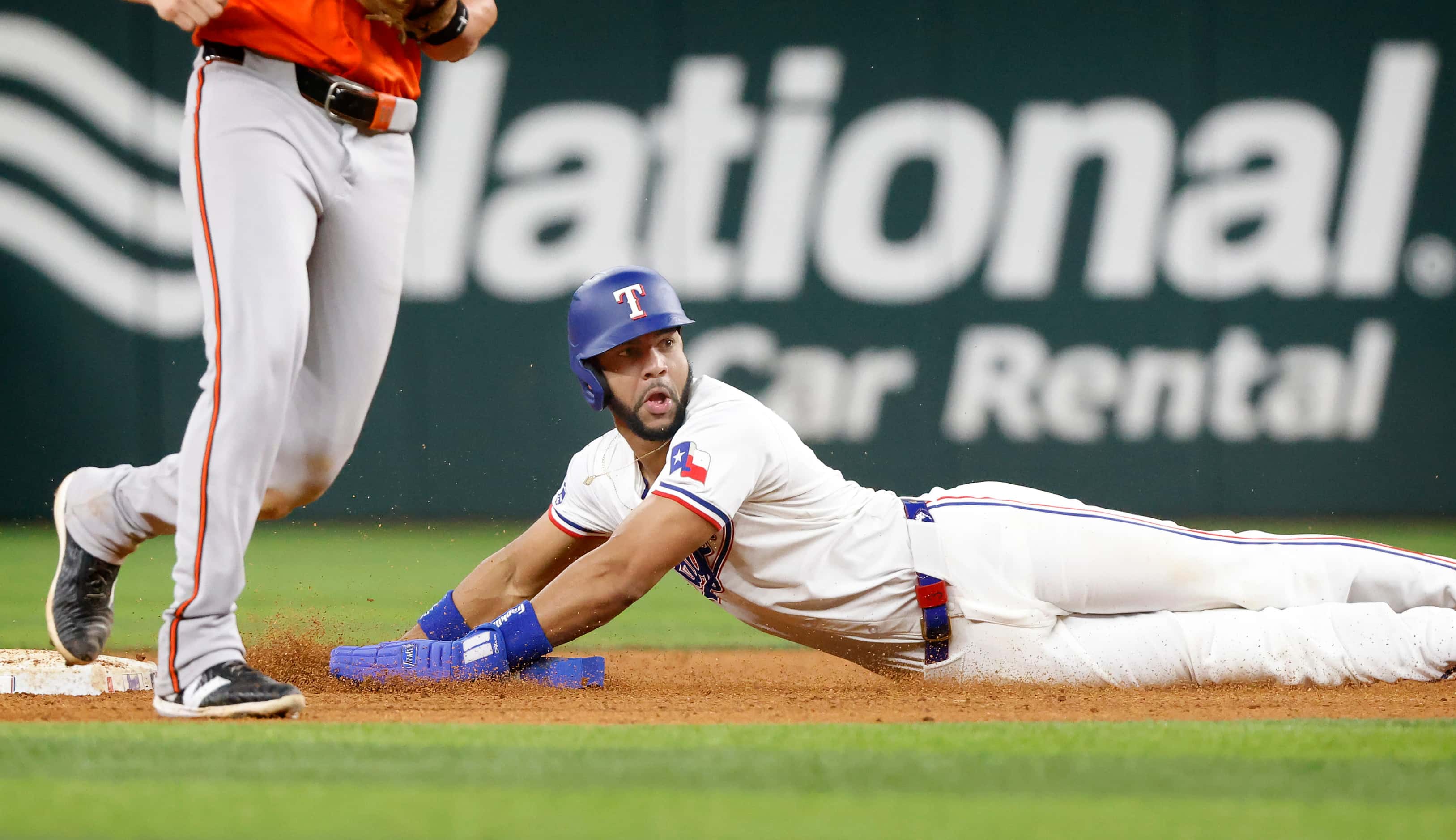 Texas Rangers outfielder Leody Taveras slides safely into second on a stolen base attempt in...