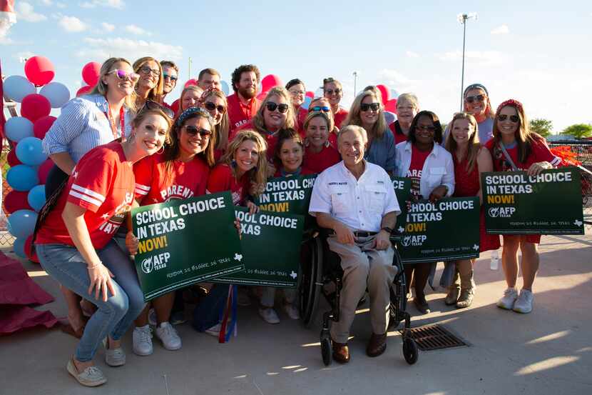 Gov. Greg Abbott (center) hosted a tailgate at the First Dallas Academy football game at the...