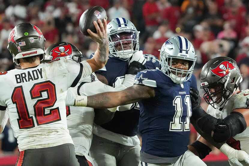 Tampa Bay Buccaneers quarterback Tom Brady (12) throws a pass under pressure from Dallas...