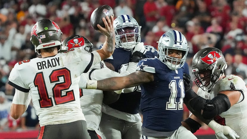 Tampa Bay Buccaneers quarterback Tom Brady throws a pass under pressure from Dallas Cowboys...