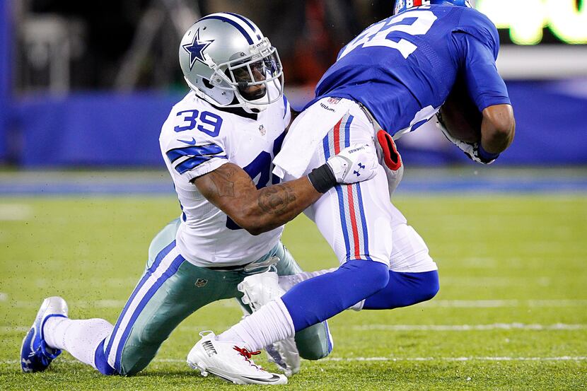 Dallas Cowboys cornerback Brandon Carr (39) tackles New York Giants wide receiver Rueben...