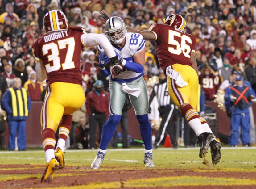 Dallas Cowboys tight end Jason Witten (82) scores a touchdown in between Washington Redskins...