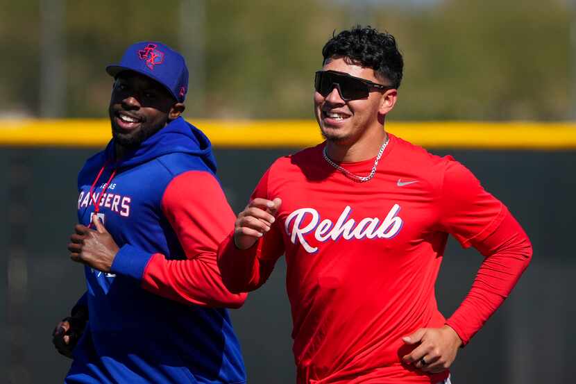 Infielder Chris Seise (right) runs with pitcher James Jones during a Texas Rangers minor...