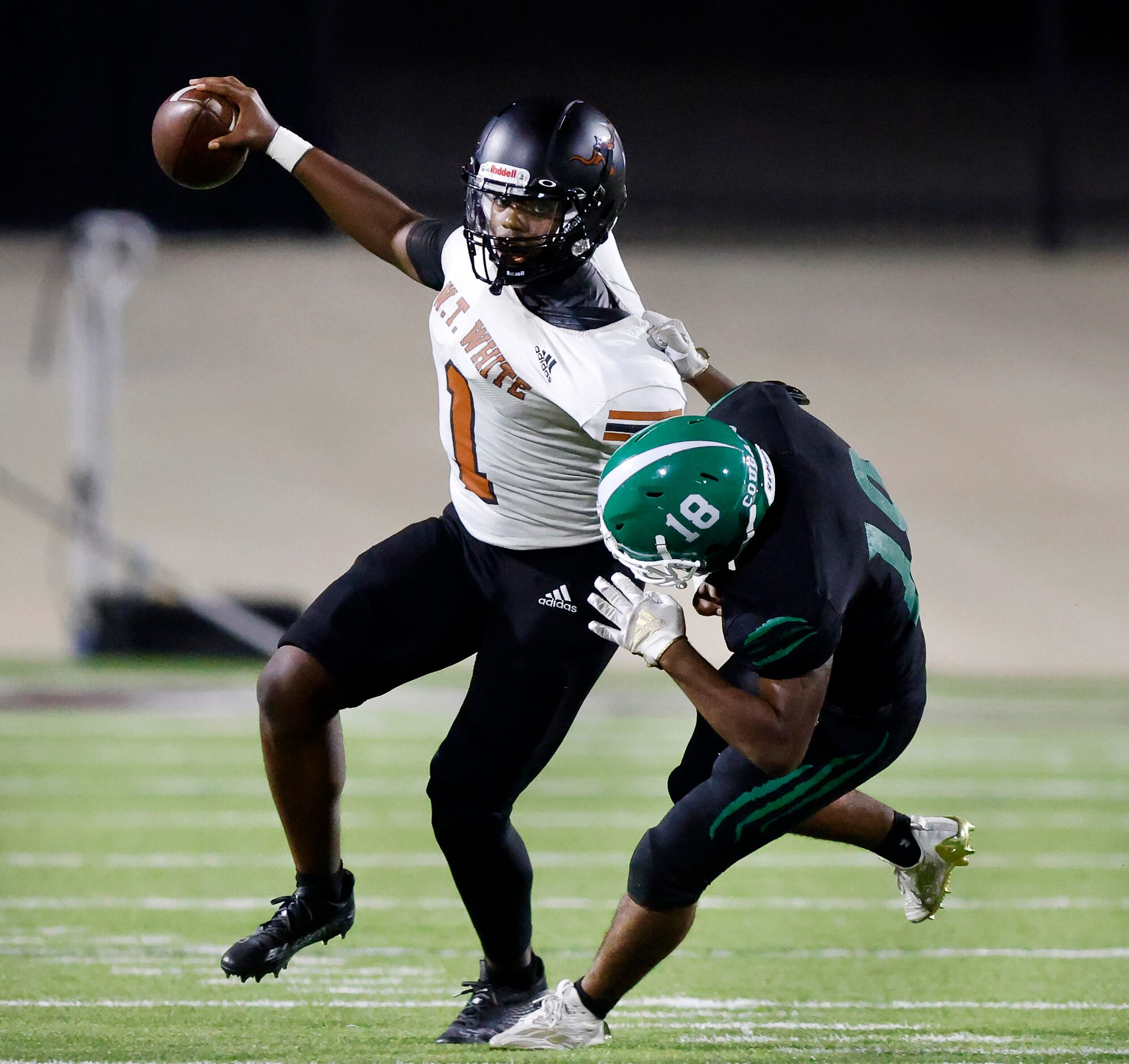 W.T. White quarterback Jaydyn Sisk (1) is sacked by  Bryan Adams linebacker Jordon Hinton...