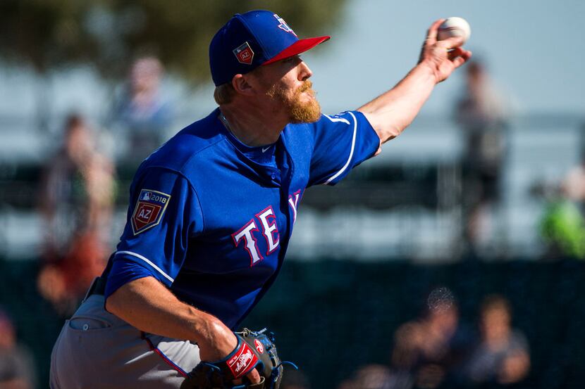Texas Rangers pitcher Jake Diekman pitches during the fourth inning of a spring training...