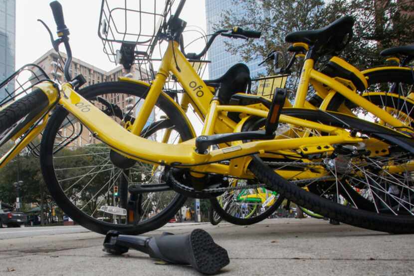 A broken kickstand causes an ofo bike to lean into other bikes in downtown Dallas on Nov. 1,...