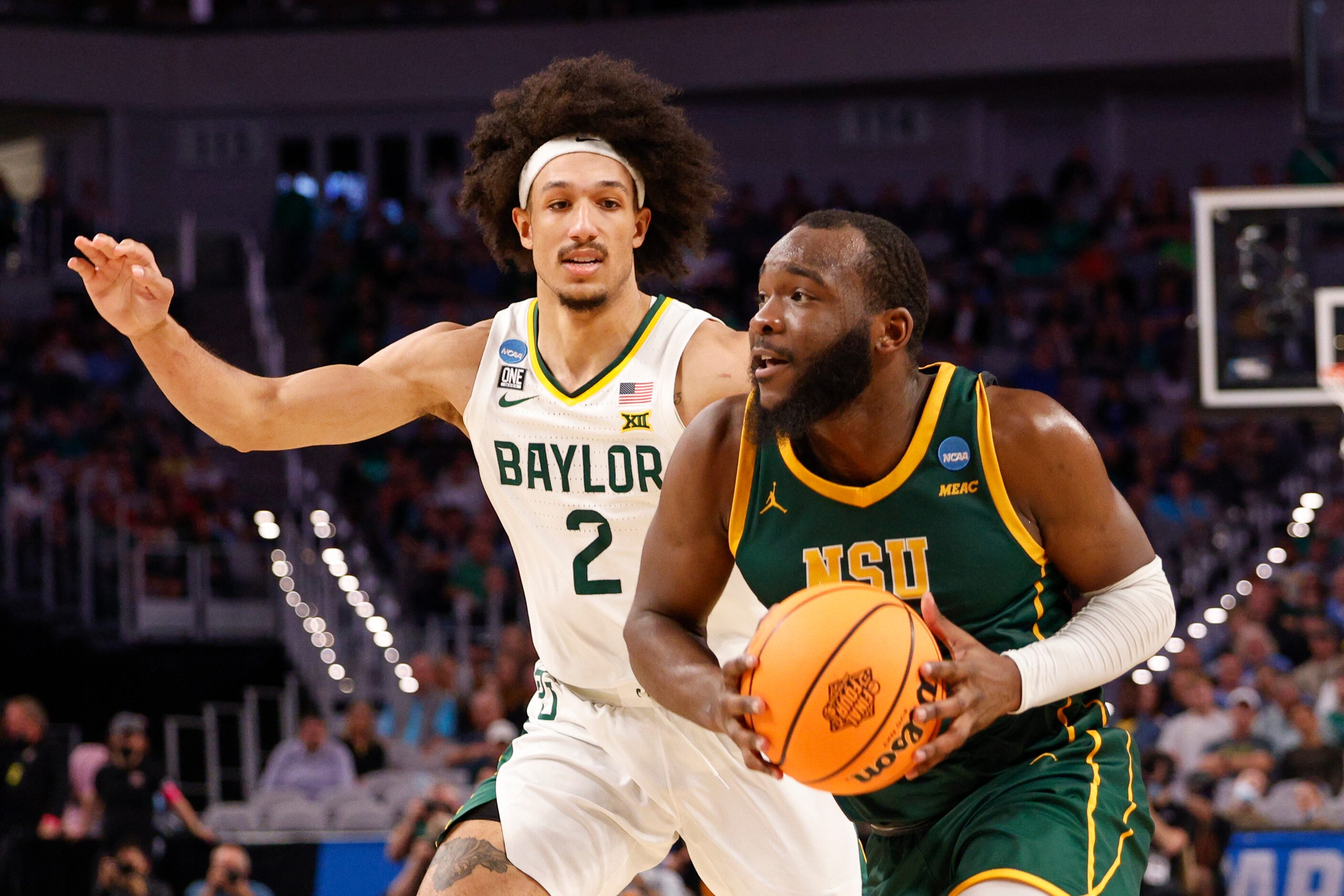 Norfolk State Spartans guard Joe Bryant Jr. (4) drives past Baylor Bears guard Kendall Brown...